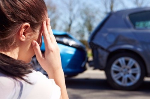 person looking at a fender bender accident